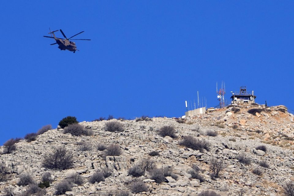 An Israeli air force Black Hawk helicopter flies over Mount Hermon, near the border with Syria (Matias Delacroix/AP)