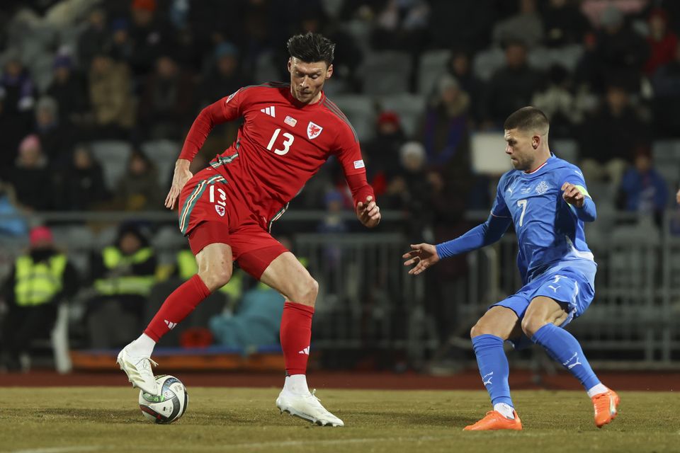 Kieffer Moore controls the ball in front of Iceland’s Johann Berg Gudmundsson in Reykjavik (Arni Torfason/AP)