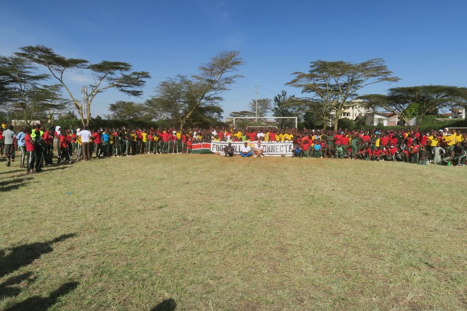 A crowd of people at the completed football pitch in Kenya (David Mulo/PA)