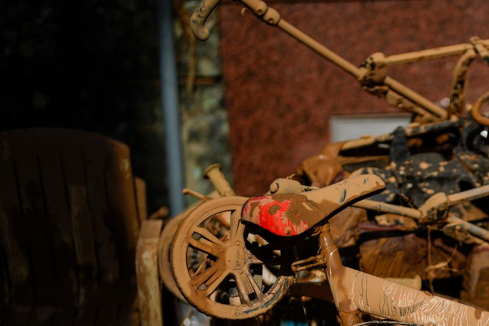 Mud covers a bicycle and various belongings in Valencia, Spain (Manu Fernandez/AP)