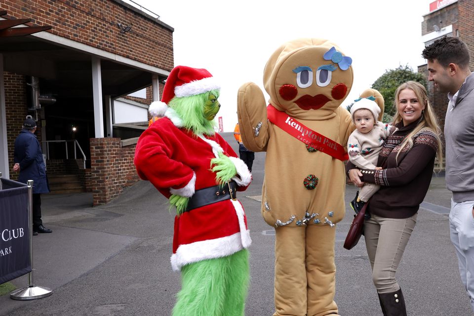 Racegoers pose with performers in Christmas fancy dress outfits on King George VI Chase Day at Kempton Park Racecourse in Surrey (Steven Paston for the Jockey Club/PA)