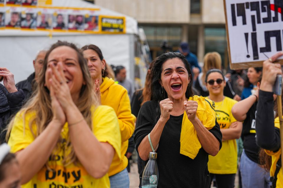 Relatives and friends of Israeli people killed and abducted by Hamas and taken into Gaza react as they follow the news of the hostages’ release in Tel Aviv (Ariel Schalit/AP)