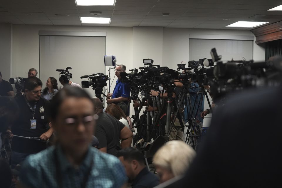 Media gather for a news conference being held by Los Angeles County District Attorney George Gascon (Damian Dovarganes/AP)