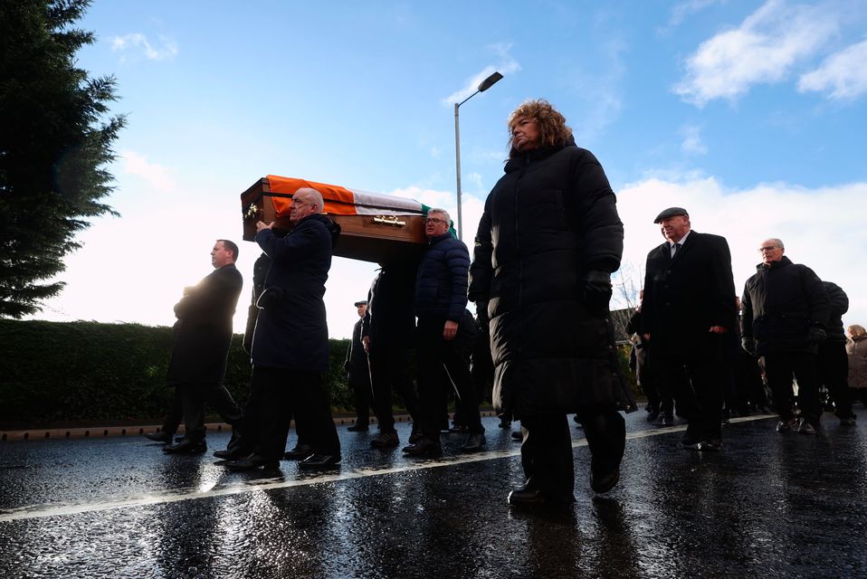 Pall bearers carry the coffin of Ted Howell as it passes though west Belfast after a funeral service. Liam McBurney/PA Wire