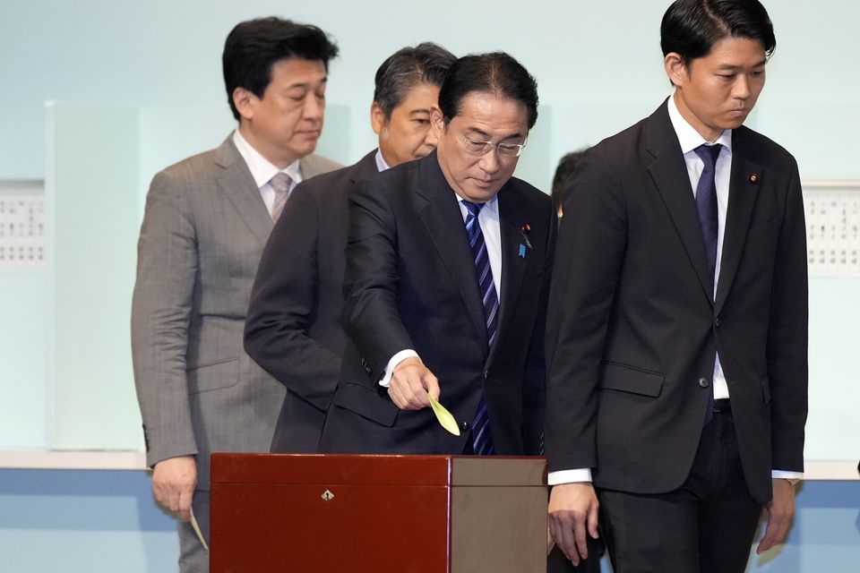 Japan’s Prime Minister Fumio Kishida, centre, casts his ballot at the Liberal Democratic Party’s leadership election in Tokyo (Hiro Komae, Pool/AP)