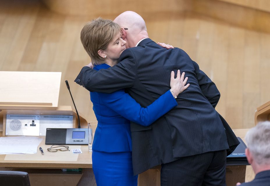 Nicola Sturgeon and John Swinney embrace after her final session of First Minister’s Questions in 2023 (Jane Barlow/PA)