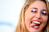 thumbnail: The beautiful game - football fans from around the world - A France supporter waits for the start of the Euro 2016 semi-final football match between Germany and France at the Stade Velodrome in Marseille on July 7, 2016.