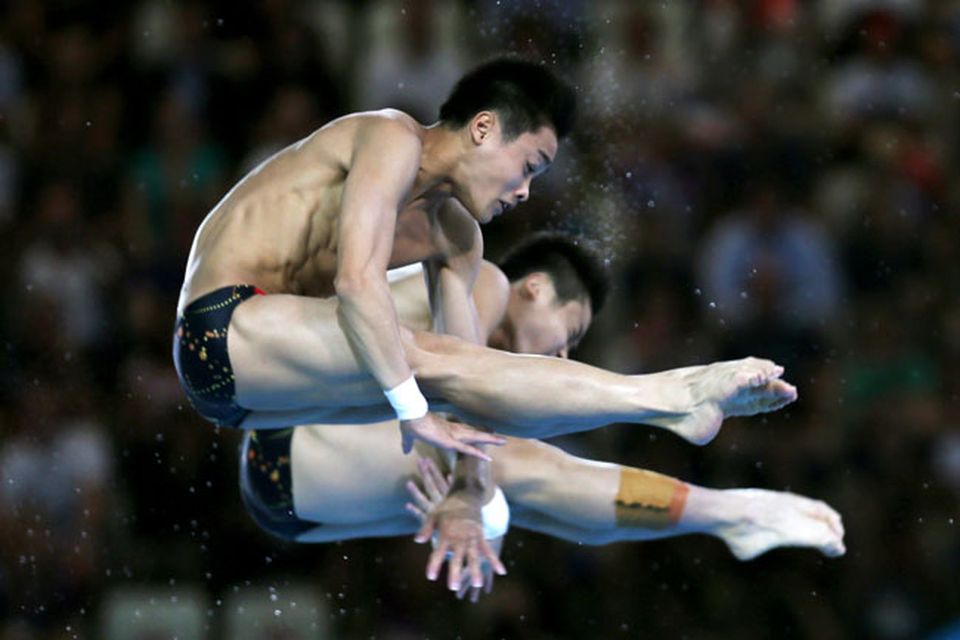 LONDON, ENGLAND - JULY 30:  Yuan Cao and Yanquan Zhang of China compete in the Men's Synchronised 10m Platform Diving on Day 3 of the London 2012 Olympic Games at the Aquatics Centre on July 30, 2012 in London, England.  (Photo by Clive Rose/Getty Images)