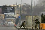 thumbnail: Israeli soldiers fire rubber bullets and throw stun grenades at Palestinian demonstrators during clashes following a demonstration against the Israeli missiles strike on Gaza, at the Kalandia checkpoint between the West Bank city of Ramallah and Jerusalem on Saturday, Dec. 27, 2008. Israeli warplanes retaliating for rocket fire from Gaza pounded dozens of security compounds across the Hamas-ruled territory in unprecedented waves of air strikes Saturday, killing at least 155 and wounding more than 310 in the bloodiest day in Gaza in decades. (AP Photo/Muhammed Muheisen)