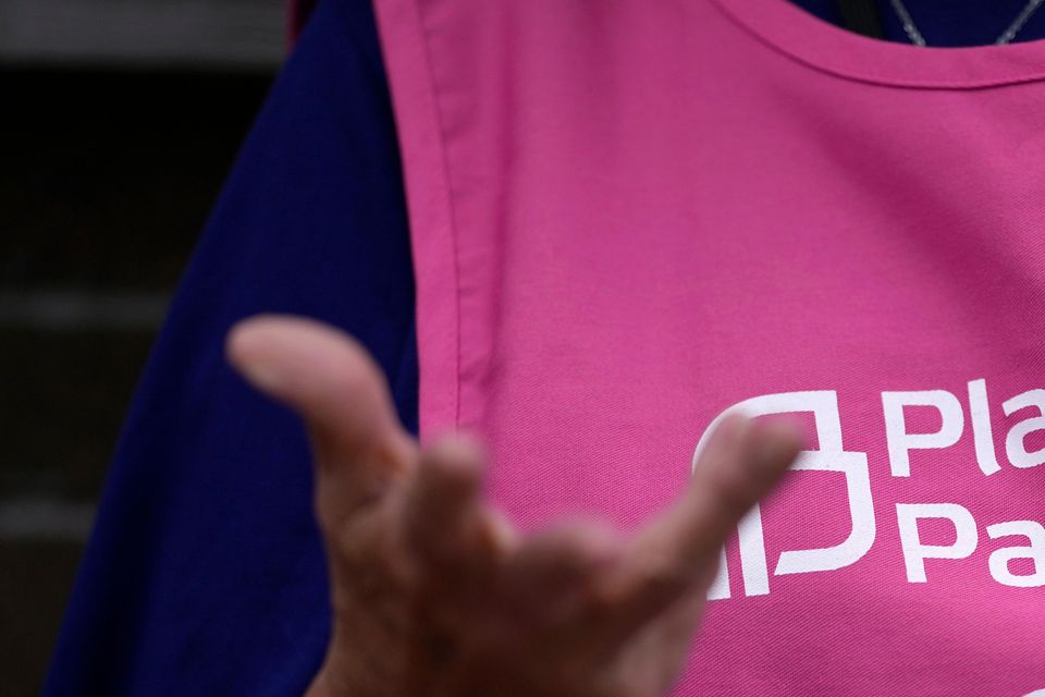 A Planned Parenthood clinic patient escort stands outside the building in Iowa (Charlie Neibergall/AP)