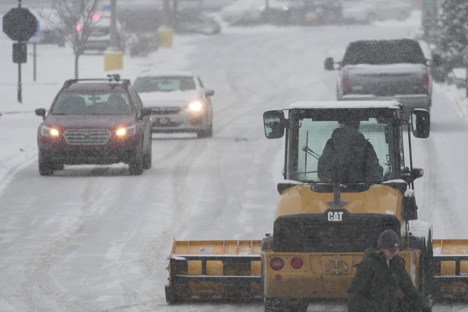 A plough clears a car park in Cincinnati (Joshua A Bickel/AP)