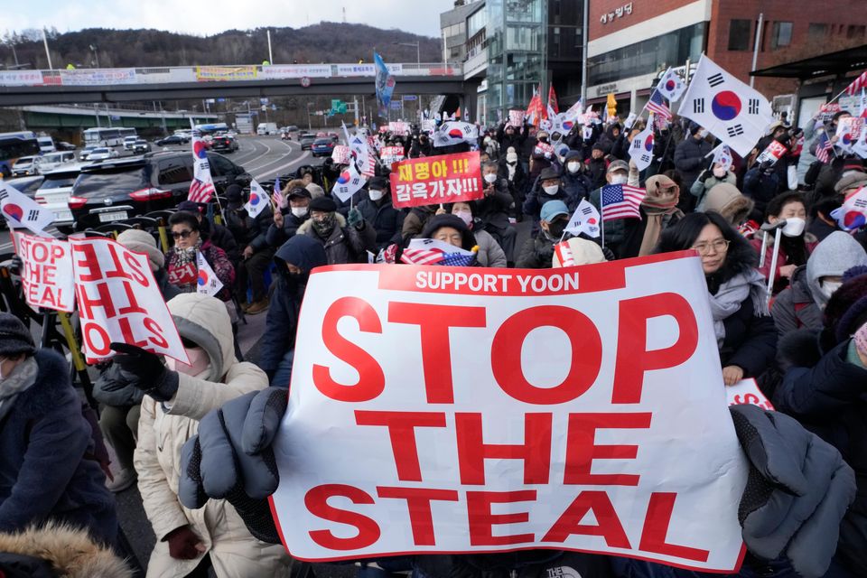 Supporters of impeached South Korean President Yoon Suk Yeol stage a rally to oppose his impeachment in Seoul (Ahn Young-joon/AP)