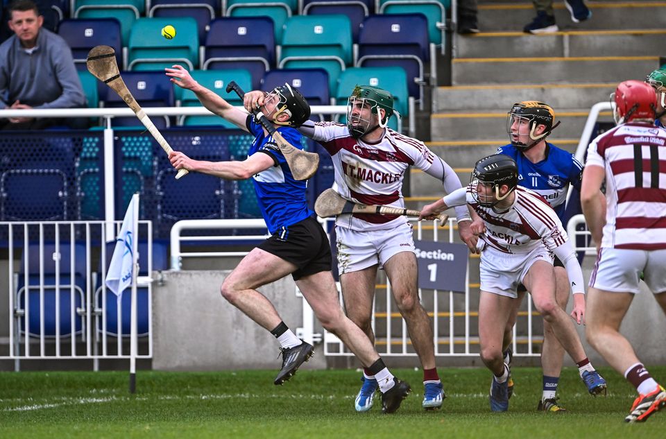 Sarsfields' Jack O'Connor looks to fend off the pressure applied by Slaughtneil counterpart Seán Cassidy