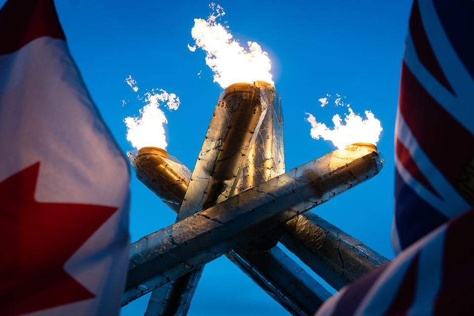 The flags of Canada and the United Kingdom fly besides the Olympic cauldron at Jack Poole Plaza in Vancouver (Aaron Chown/PA)