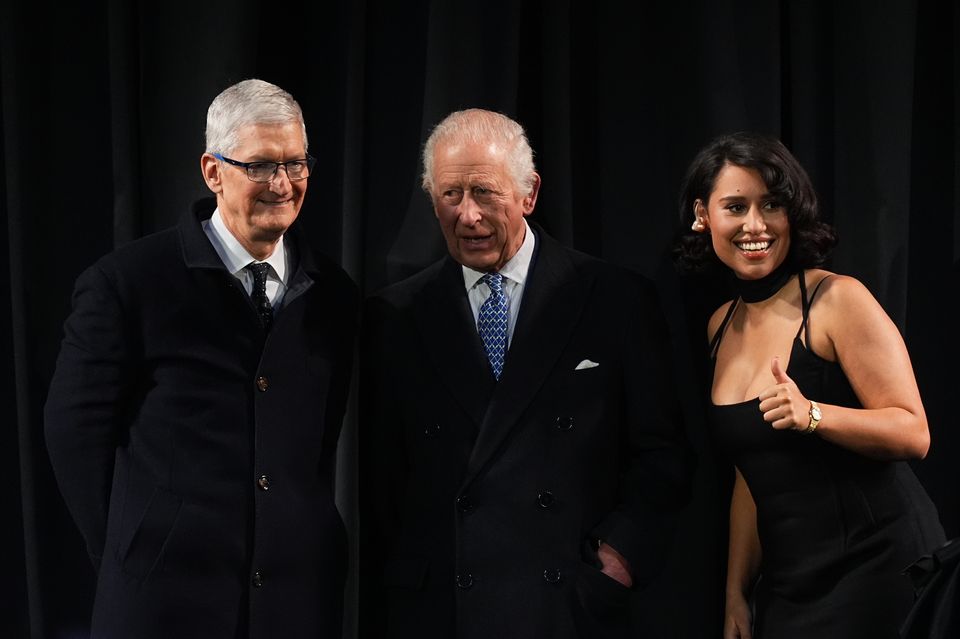 Charles, centre, with Apple chief executive Tim Cook, left, and singer Raye (Aaron Chown/PA)