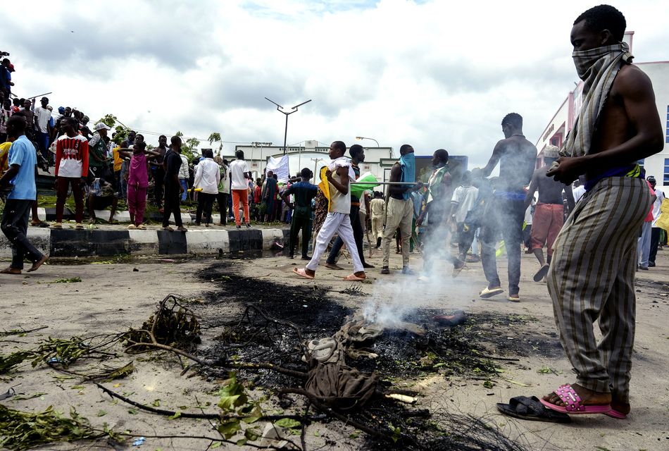 The Nigerian leader said his government will not permit looting and other disorder (Sani MaIkatanga/AP)