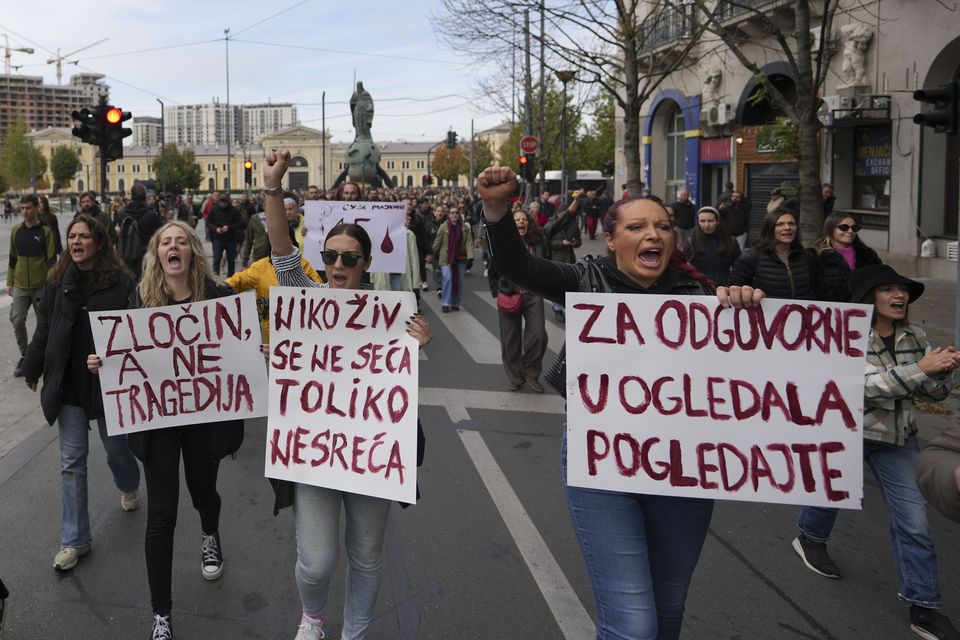 Protesters held banners with slogans reading ‘Corruption kills’ and ‘We are all under the canopy!’ (Darko Vojinovic/AP)