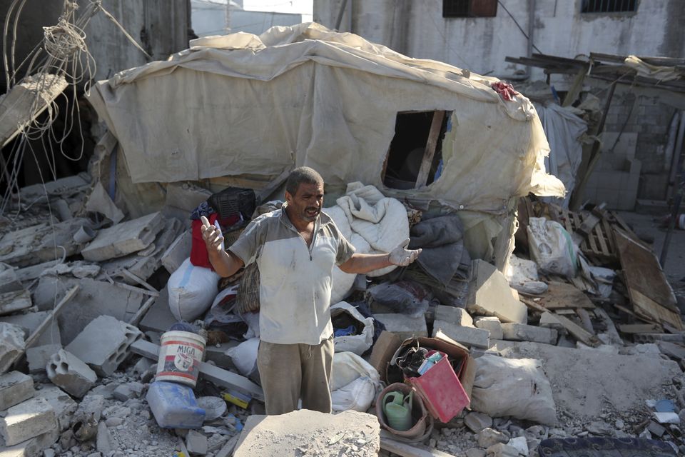 A man reacts as he stands on the rubble of a building hit in an Israeli airstrike in the southern village of Akbieh, Lebanon (Mohammed Zaatari/AP)