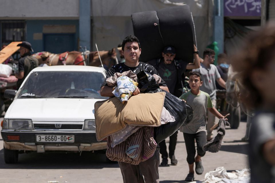 Palestinians evacuate a school in eastern Deir al-Balah, Gaza Strip (Abdel Kareem Hana/AP)