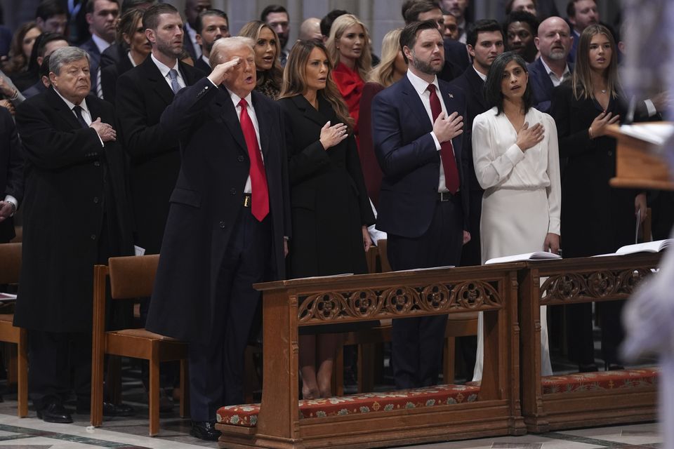 Donald Trump salutes, alongside first lady Melania Trump, vice president JD Vance and his wife Usha Vance during the national prayer service at the Washington National Cathedral (Evan Vucci/AP)