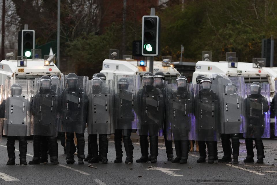 PSNI officers with riot shields line the Springfield road, during further unrest in Belfast (Liam McBurney/PA)