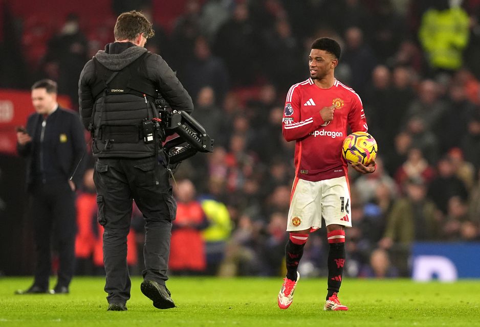 Amad Diallo celebrates with the match ball after scoring a hat-trick (Martin Rickett/PA)