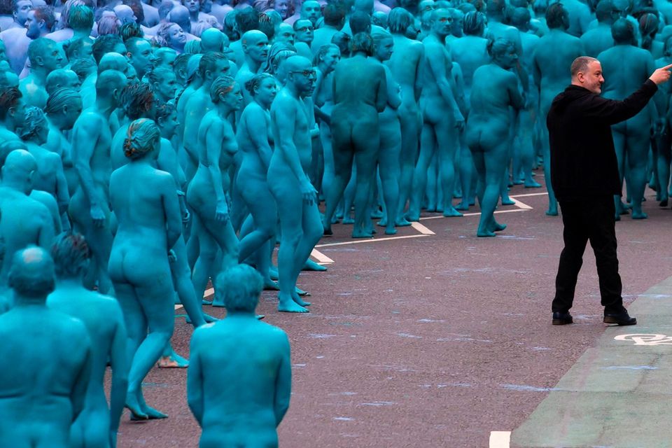 US artist Spencer Tunick, (wearing black) organizes Naked volunteers, painted in blue to reflect the colours found in Marine paintings in Hull's Ferens Art Gallery, as they prepare to participate in US artist, Spencer Tunick's "Sea of Hull" installation in Kingston upon Hull on July 9, 2016. AFP/Getty Images