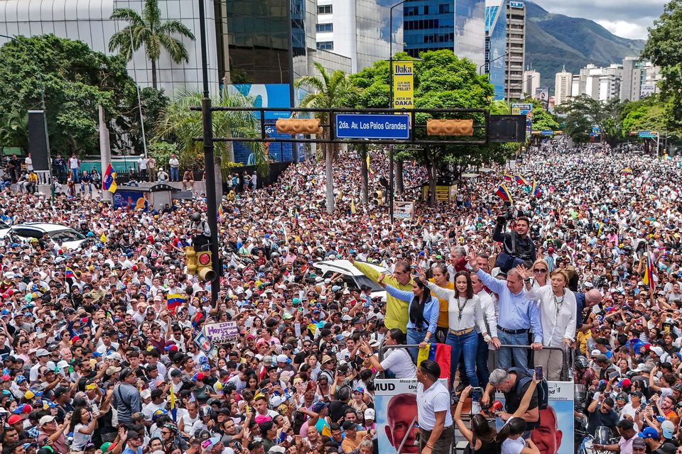 Opposition leader Maria Corina Machado and opposition candidate Edmundo Gonzalez ride atop a truck during a protest against official presidential election results (Matias Delacroix/AP)