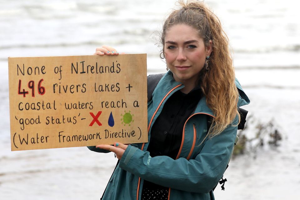Ruby holding a sign highlighting the worrying state of our rivers