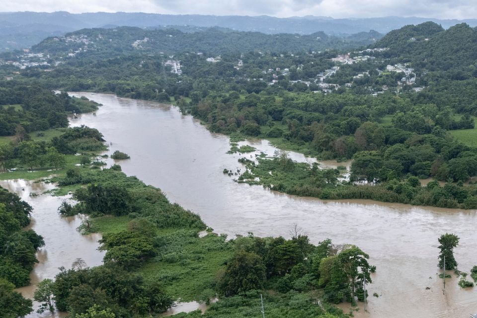 La Plata river floods a road after Tropical Storm Ernesto passed through Toa Baja, Puerto Rico (Alejandro Granadillo/AP)