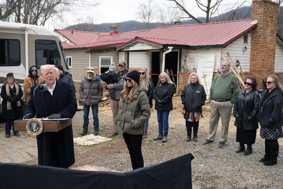 President Donald Trump speaks along side first lady Melania Trump, as they meet with homeowners affected by Hurricane Helene in Swannanoa (Mark Schiefelbein/AP)