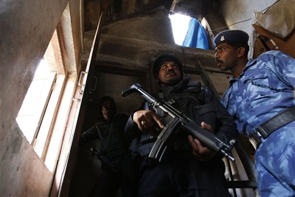 National Security Guard commandoes take position near an apartment where suspected gunmen have held a family hostage in Colaba, Mumbai, India, Thursday, Nov. 27, 2008. Teams of gunmen stormed luxury hotels, a popular restaurant, hospitals and a crowded train station in coordinated attacks across India's financial capital, killing at least 101 people, taking Westerners hostage and leaving parts of the city under siege Thursday, police said. A group of suspected Muslim militants claimed responsibility. (AP Photo/Saurabh Das)