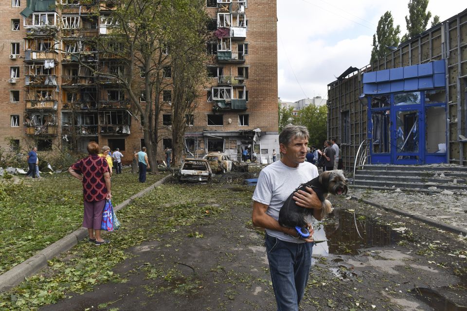 Residents of an apartment building damaged by shelling by Ukrainian forces leave the area in Kursk, Russia (AP)