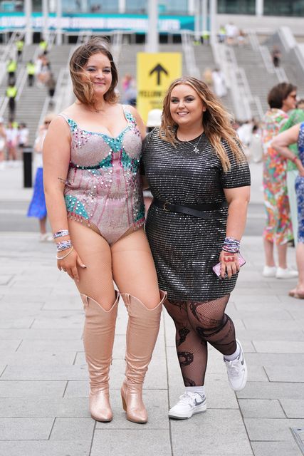 Katie Jackson, 18, wearing a homemade Taylor Swift bodysuit, and Kacey Tinsley, 20, pose for a photo outside Wembley Stadium (James Manning/PA)