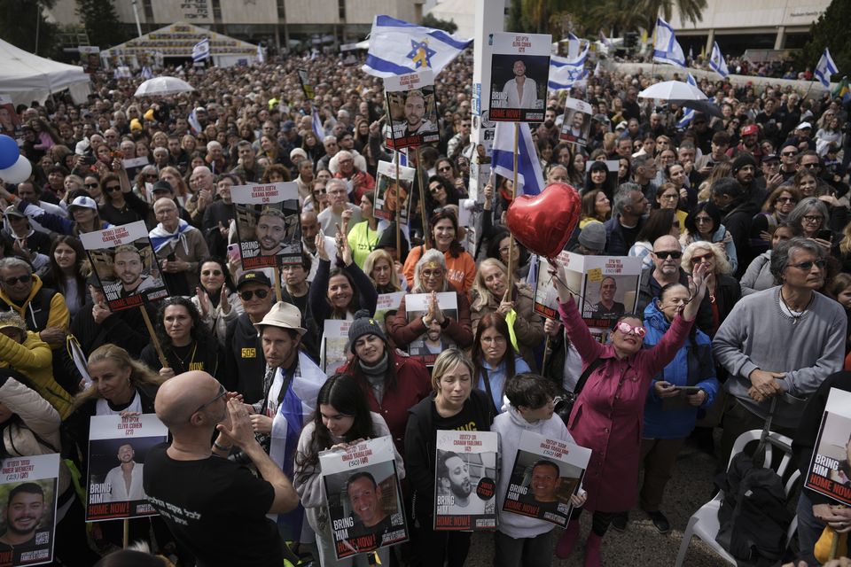 Israelis react as Palestinian militants hand over the hostages to the Red Cross in the Gaza Strip (AP/Oded Balilty)