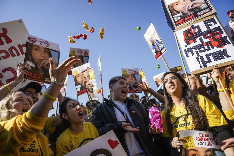 People react as they watch a broadcast of the release of Israeli soldier Agam Berger in Tel Aviv, Israel (Oded Balilty/AP)