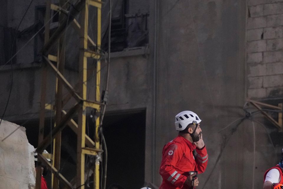 Rescuers search for victims at the site of an Israeli air strike in Beirut (Hassan Ammar/AP)