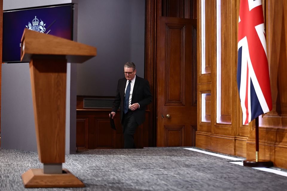 The carpet on the podium and the panels around the TV screen have been replaced with politically neutral grey (Henry Nicholls/PA)