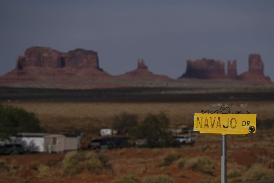 A sign marks Navajo Drive, as Sentinel Mesa stands in the distance (Carolyn Kaster/AP)