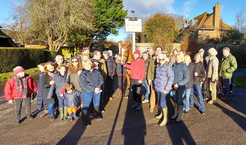 The racehorse with admirers outside his local pub (Fiona Browne/PA)