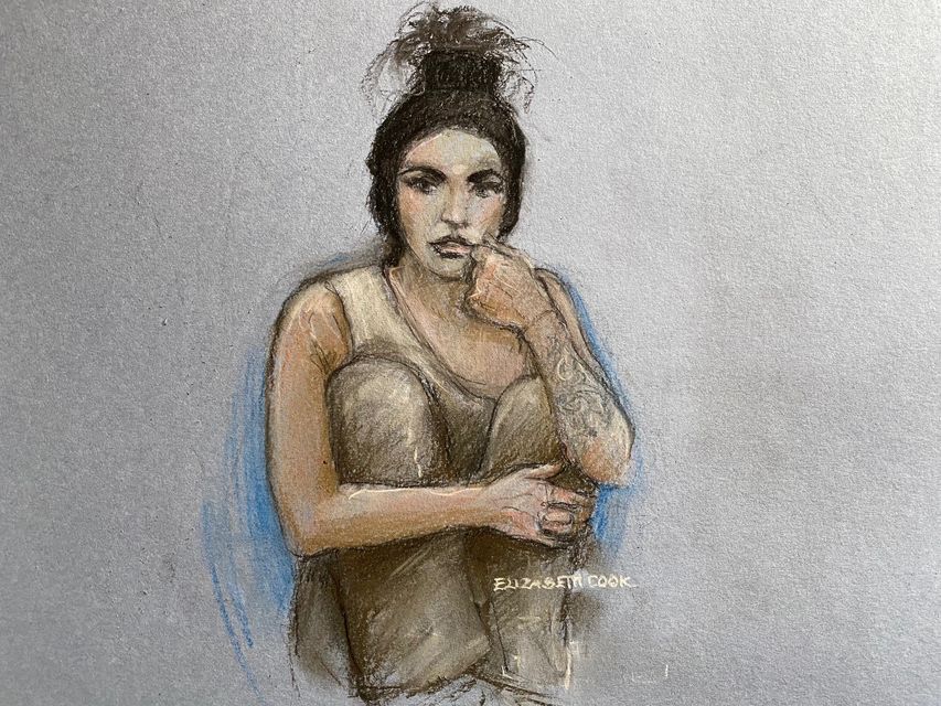 Court artist sketch of Katie Price sitting with her knees up while appearing by video link before a specialist bankruptcy judge (Elizabeth Cook/PA)