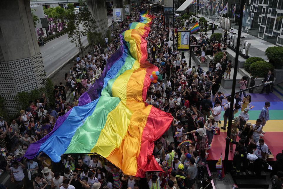 Participants hold a rainbow flag during the Pride parade in Bangkok, Thailand (Sakchai Lalit/AP)