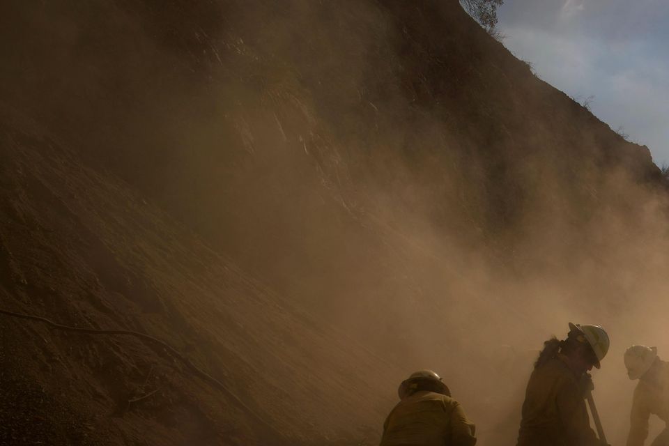 Members of the Navajo Scouts firefighter crew kick up dust (John Locher/AP)