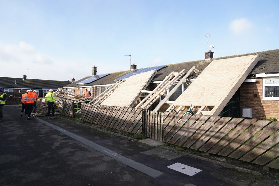 A roof blown off during strong winds rests on some bungalows in Amble, Northumberland (Owen Humphreys/PA)