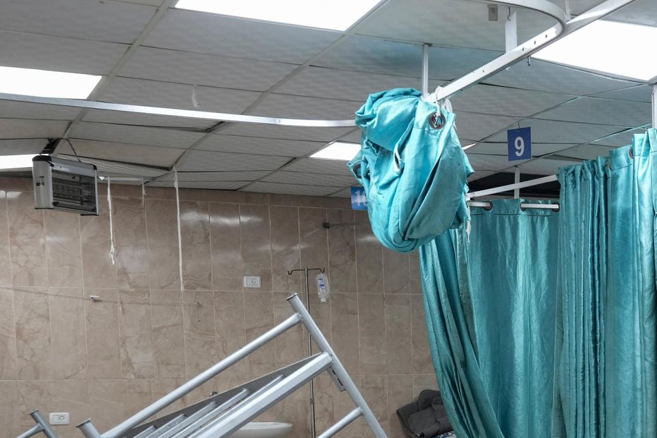 A woman sits on a bed in a room of the Al-Aqsa Martyrs hospital in Deir al Balah (Abdel Kareem Hana/AP)