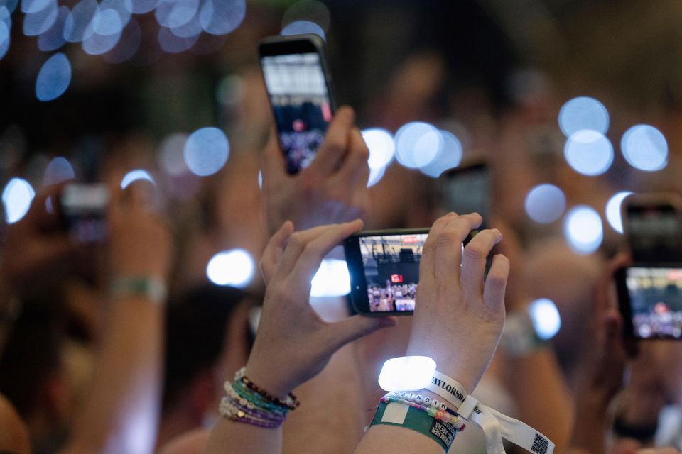 Spectators film with their smartphones during singer Taylor Swift’s concert in the Veltins Arena in Gelsenkirchen (Marius Becker/dpa via AP)