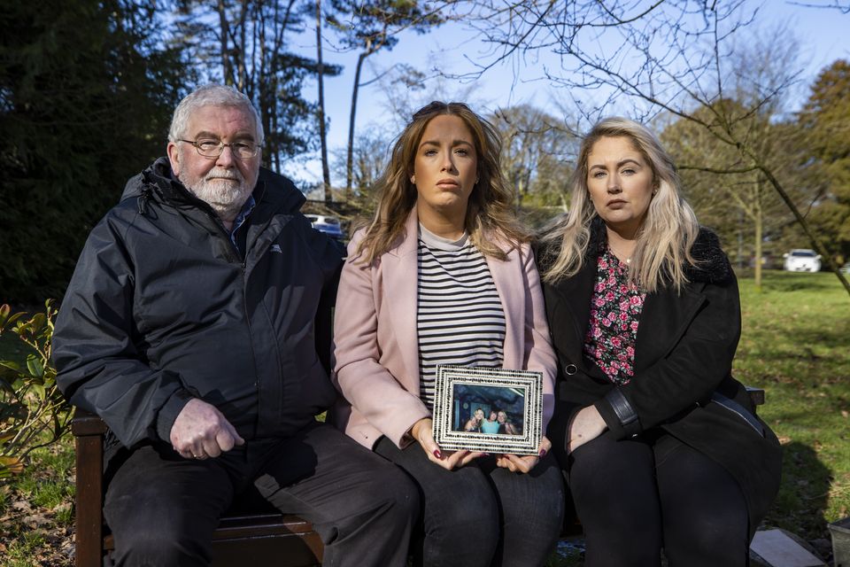 Lisa Dorrian’s father John and her sisters Michelle (centre) and Joanne (right) sitting at a memorial bench to Lisa in Bangor in 2021 (Neil Harrison/WAVE/PA)