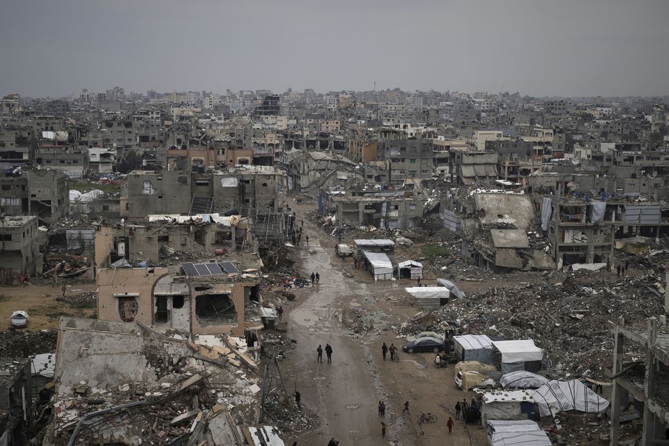 Palestinians walk surrounded by the rubble of destroyed homes and buildings in the Zeitoun neighbourhood of Gaza City (AP Photo/Jehad Alshrafi)