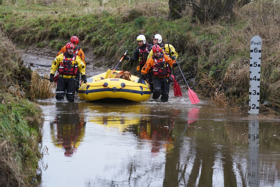 Searchers looking for Tom Voyce enter the River Aln near Alnwick, Northumberland (Owen Humphreys/PA)