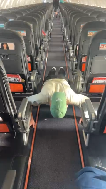 Alex Welford completing his press-ups on an aeroplane so he can reach his goal of 100,000 press-ups over the year (Alex Welford/PA)